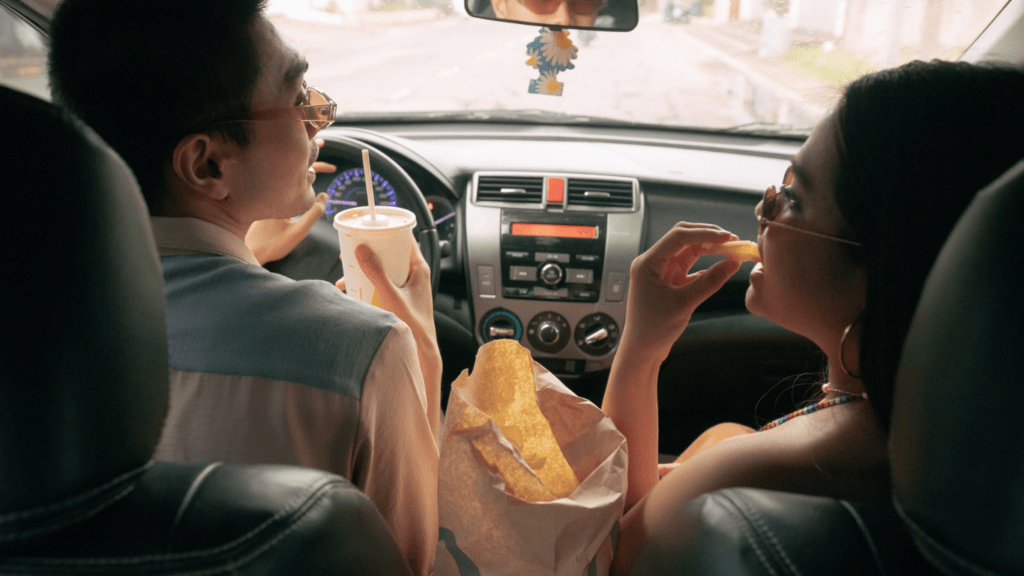 Couple eating fries while on the road trip